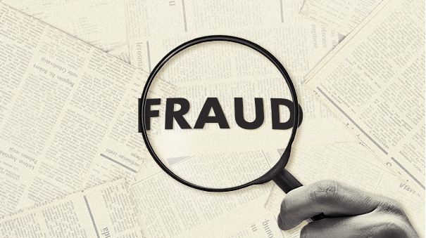 The word FRAUD under a magnified glass.